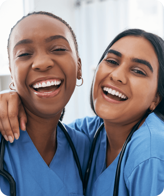 two clinicians embracing and smiling
